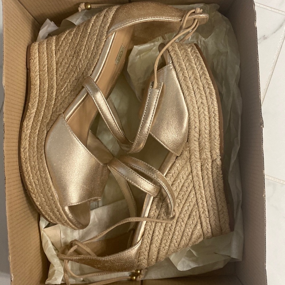 New! Never worn. UGG Reagan gold metallic wedge espadrilles. Sz 8.5 or EU 39.5